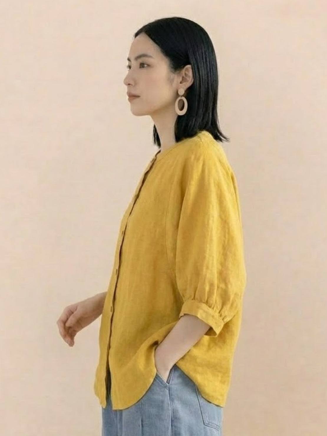 woman wearing relaxed loose breathable linen yellow blouse with rolled sleeves and front buttons