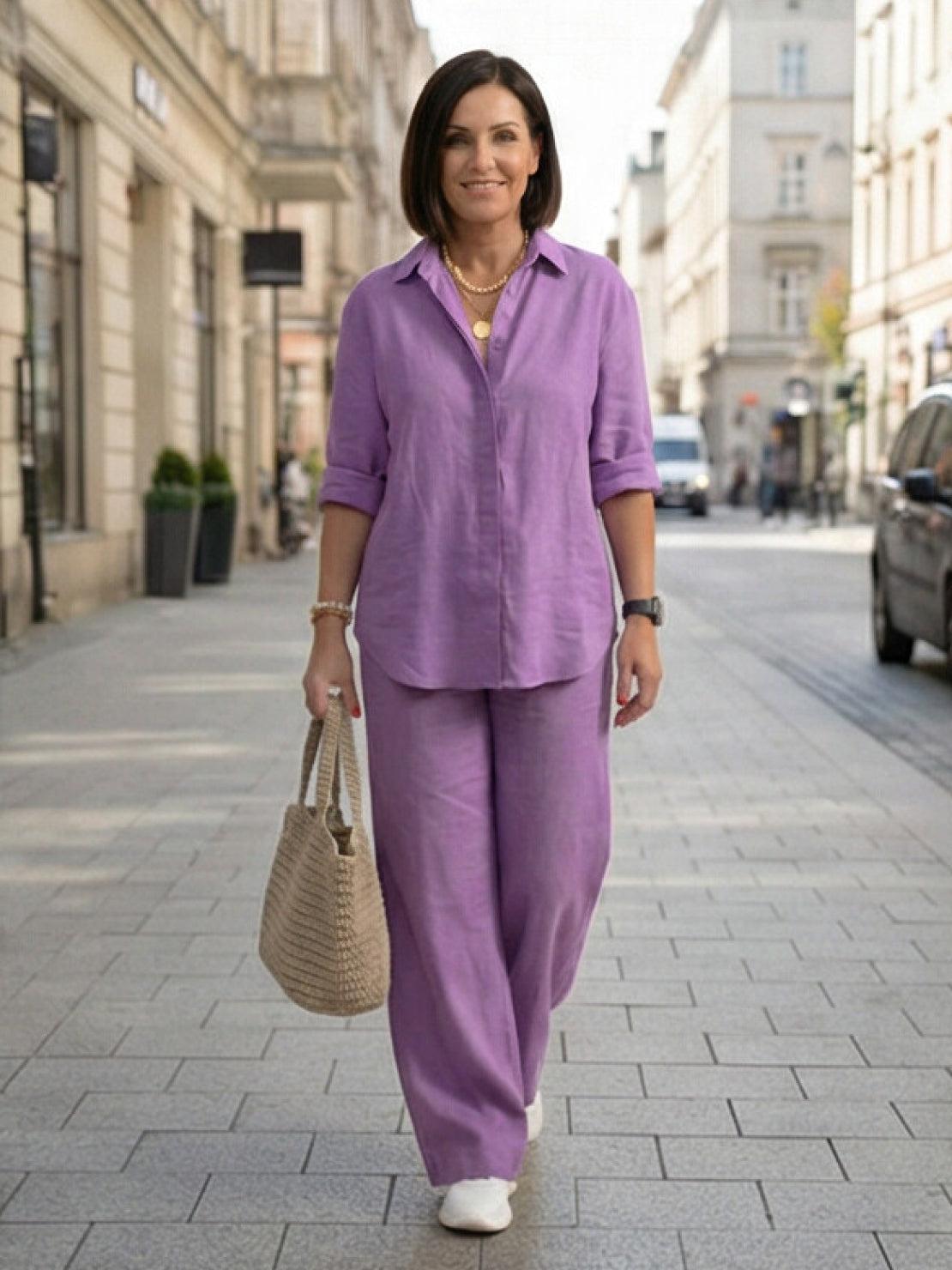 Woman wearing a monochrome relaxed shirt and trousers two-piece set standing outdoors