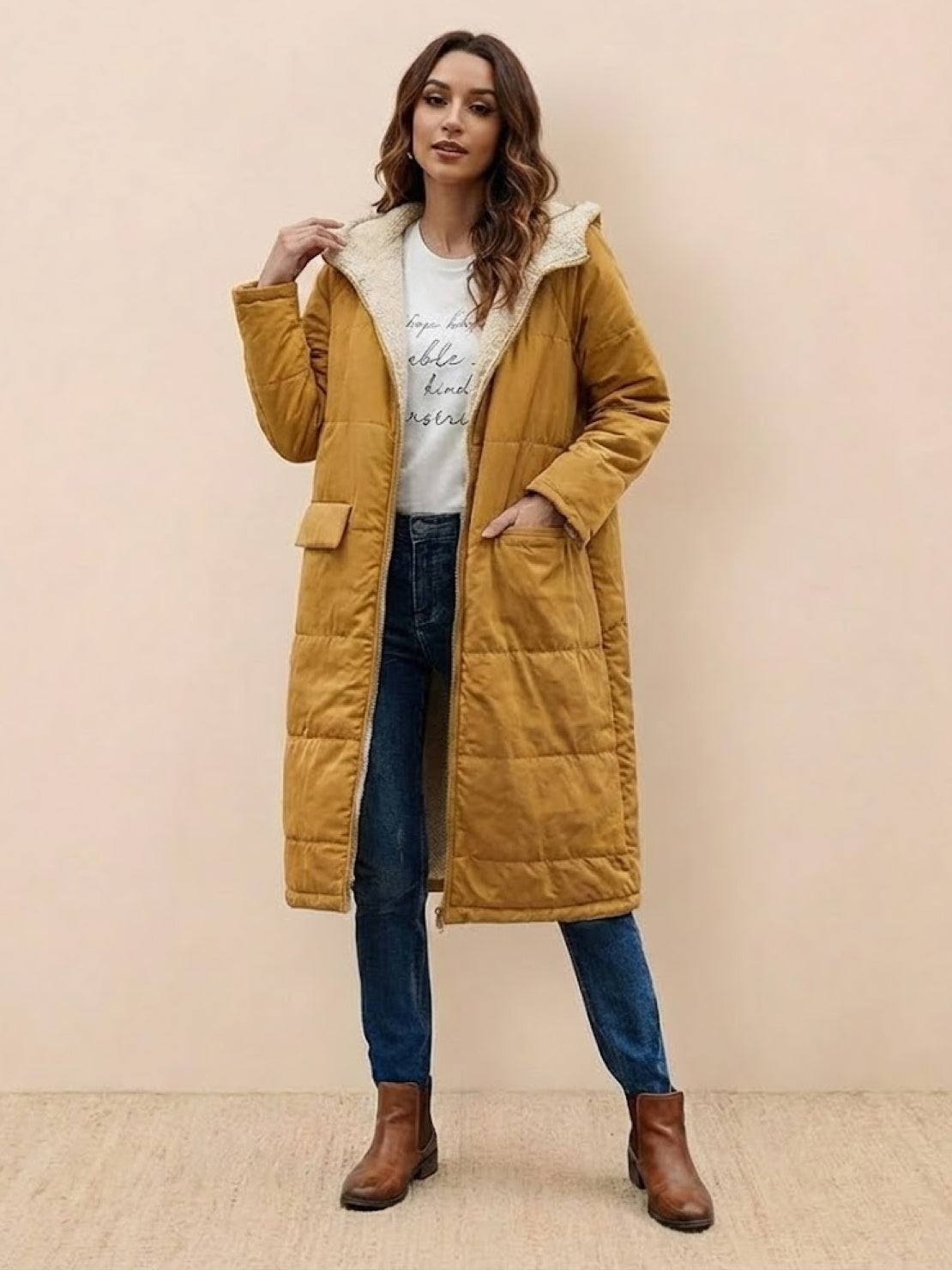 Woman wearing mustard sherpa-lined hooded teddy coat with pockets and jeans