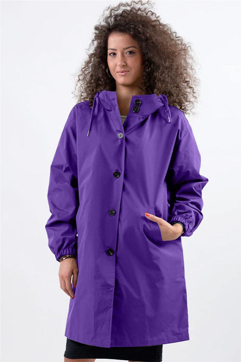 Woman wearing purple oversized Rain Couture Windbreaker water-resistant jacket with hood and button front closure