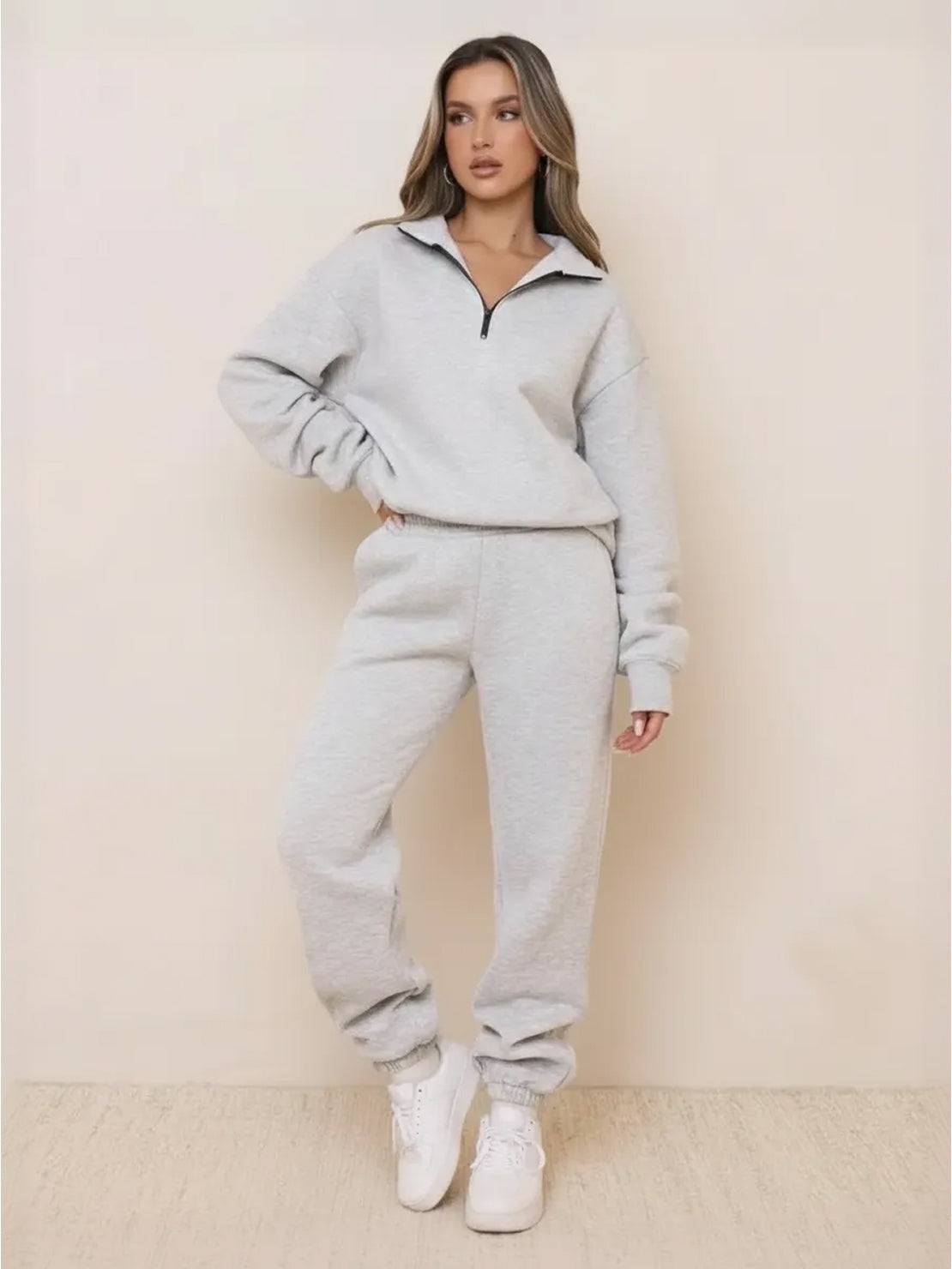 Woman wearing ultra-soft and comfy co-ord tracksuit set in light grey with zip-up top and matching jogger pants