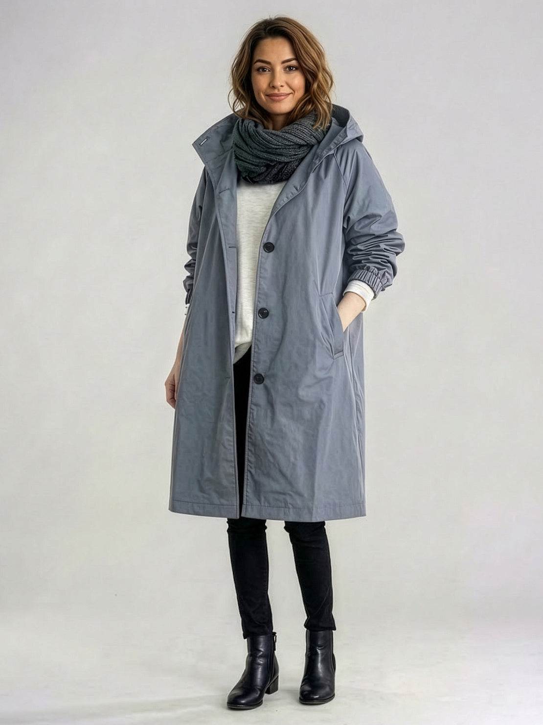 water-resistant oversized hooded windbreaker rain jacket on a mannequin with front zipper and pockets