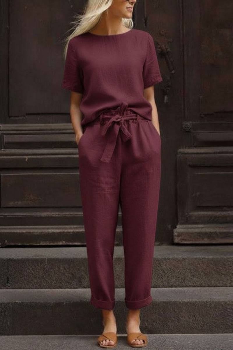 Woman wearing relaxed fit cotton linen set with short-sleeve top and straight-leg pants in maroon color