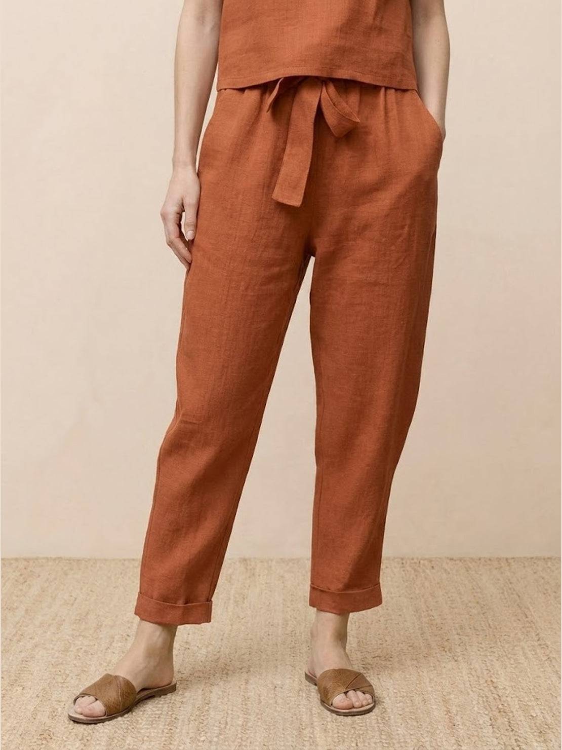 Woman wearing a relaxed cotton linen set with short-sleeve top and straight-leg pants in monochrome tones