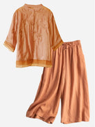 woman wearing 100% cotton linen tuscany embroidered top and wide-leg trousers set