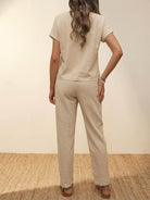 Woman wearing beige 100% cotton total comfort two-piece set with short sleeves and long pants, back view.