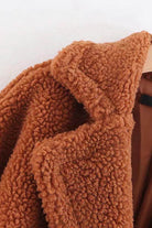 Close-up of a brown glamour teddy coat made of polyester and lambswool with a soft, textured fabric.