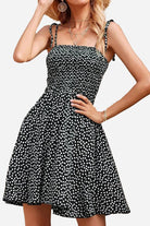 Black and white bohemian skater dress with polka dots and sling knot straps