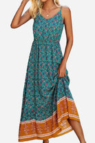 Woman wearing a vintage flower prints maxi dress with spaghetti straps and elastic waist