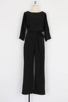 Black casual long sleeve belted jumpsuit with round neck and wide legs on mannequin