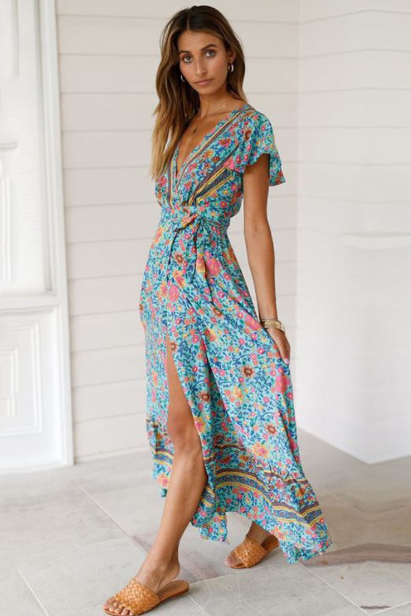 Bohemian floral print wrap dress with V-neck and high slit, worn by woman in casual setting