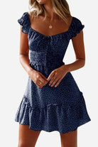 Woman wearing navy blue sweetheart collar printed ruffled maxi dress with short sleeves