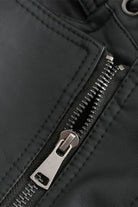 Close-up of zipper detail on slim fit leather motorcycle jacket in black
