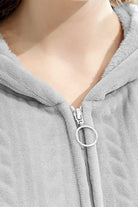 Close-up of stylish flannel nightgown zipper and soft hood collar in light grey fabric