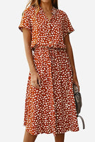 Woman wearing casual bohemian dress skirt with orange and white dot print and lace-up waist