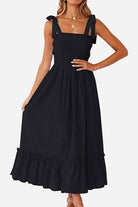 Black Sunkissed Spaghetti Boho Dress with adjustable tie-up straps and flowy high-waist silhouette for summer comfort and style