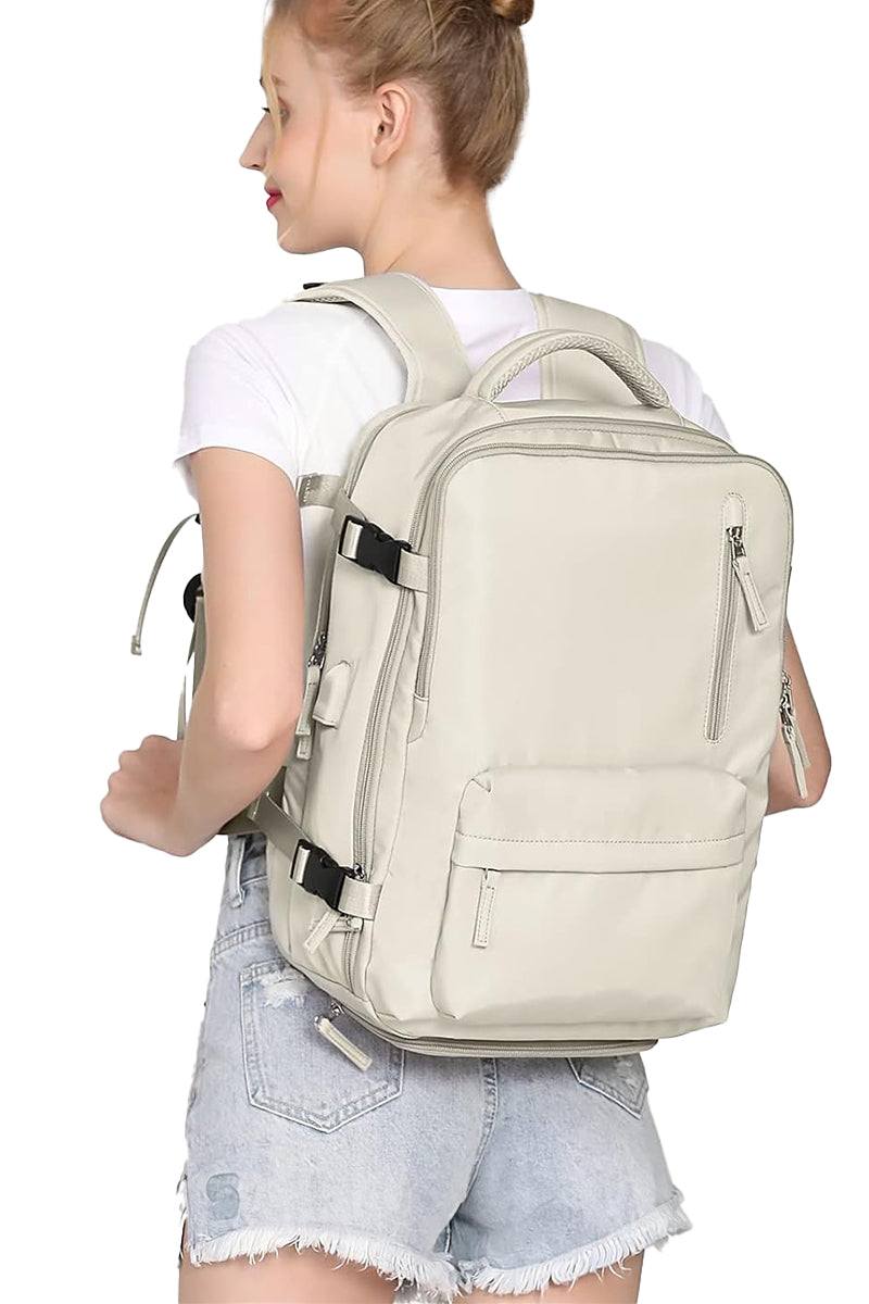 Chic Wanderlust Waterproof Backpack in beige, worn by woman, multiple pockets, ergonomic straps, travel and urban style.