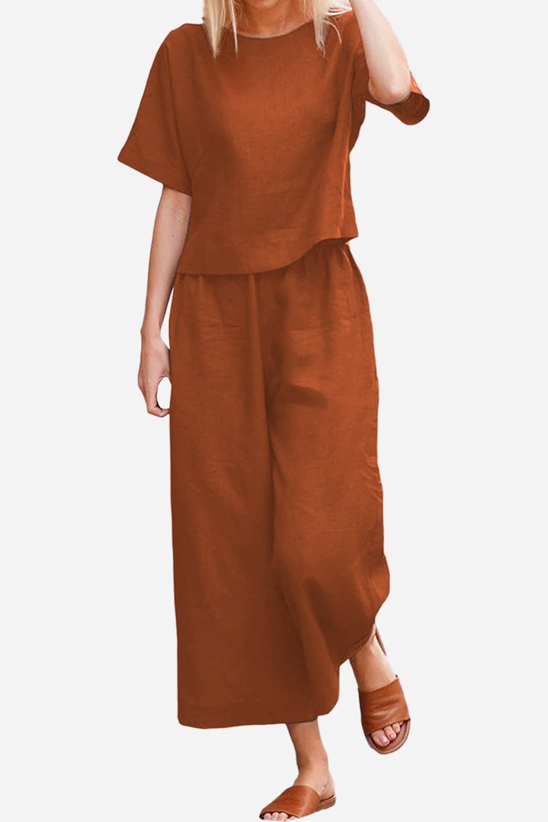 Woman wearing rust brown loose fit co-ord set with short sleeves and wide-leg pants