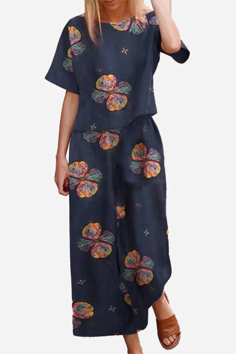 Women's loose fit co-ord set with navy floral print top and wide-leg trousers, relaxed and breathable design.