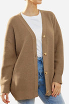 Relaxed fit oversized brown knit cardigan with button down front worn over white shirt and jeans