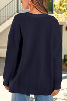 Relaxed fit oversized navy knitwear cardigan back view on model outdoors
