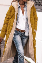 Long mustard sherpa-lined hooded teddy coat with quilted puffer exterior and cozy plush interior worn with casual denim and white shirt