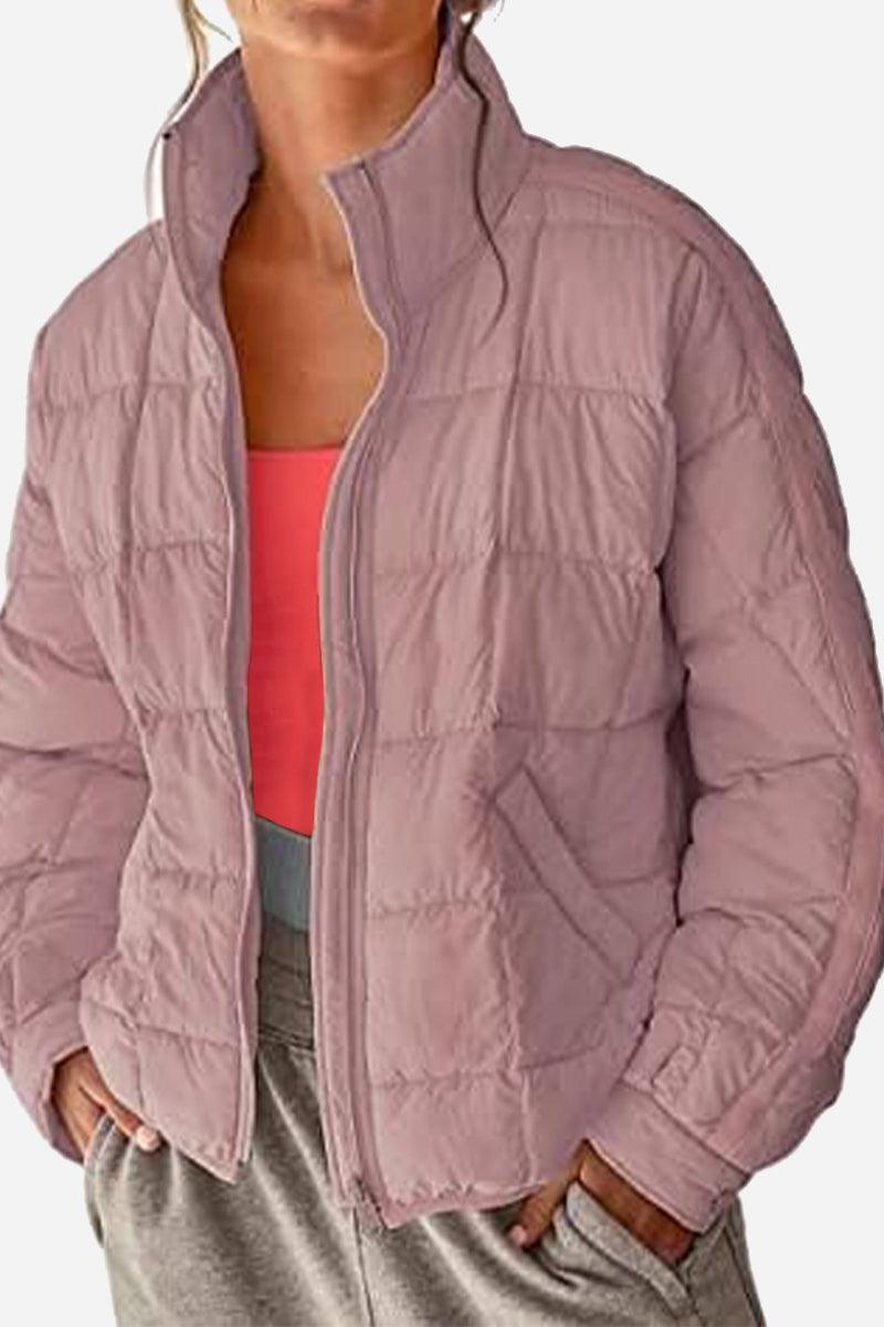 Lightweight puffer travel jacket displayed on a white background, showing its compact, travel-ready design and versatile style in black color.