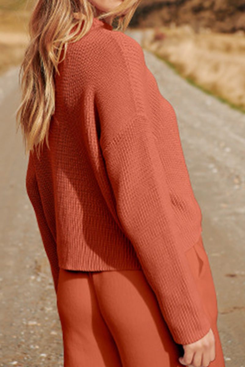 Woman wearing relaxed knit sweater top and trouser set in earthy tones inspired by European Minimalism on outdoor path