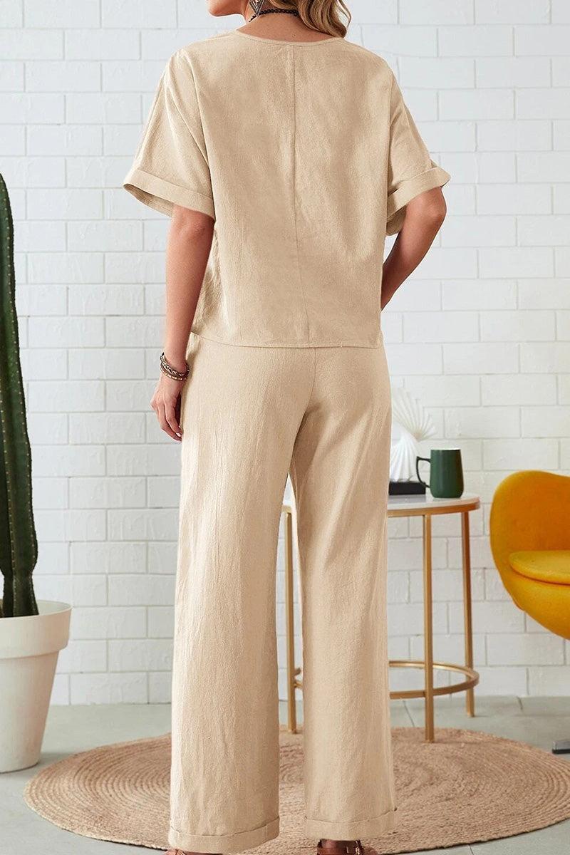 Woman wearing beige rolled cuff top and patch pocket pants set, casual relaxed fit outfit from back view