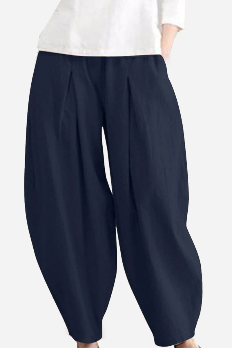 Solid color wide leg cotton pleated pants in navy blue with a voluminous fit and comfortable breathable fabric