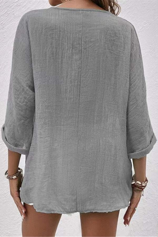 Back view of grey crinkled button front tunic with rolled sleeves and relaxed fit