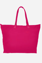 Bright pink waterproof travel bag with sturdy handles and spacious interior for versatile use
