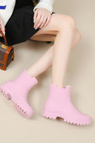Pink non-slip rain boots with SuperGrip soles, waterproof and lightweight for comfort and easy cleaning.