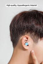 Man wearing blue noise-blocking earplugs from Travel Comfy Kit made of high-quality hypoallergenic material