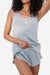 Woman wearing light blue Mulberry silk tank and shorts set lounging comfortably