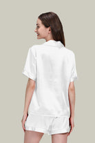 Woman wearing white Mulberry Silk Essentials buttoned short set nightwear, back view, soft breathable silk pajamas