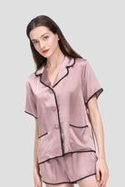 Woman wearing pink Mulberry Silk Hemd pajama set with black hems and shorts