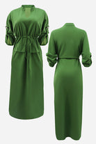 Green All-Day Drape Dress with adjustable waist tie, button-tab sleeves, front slit, and breathable polyester fabric.