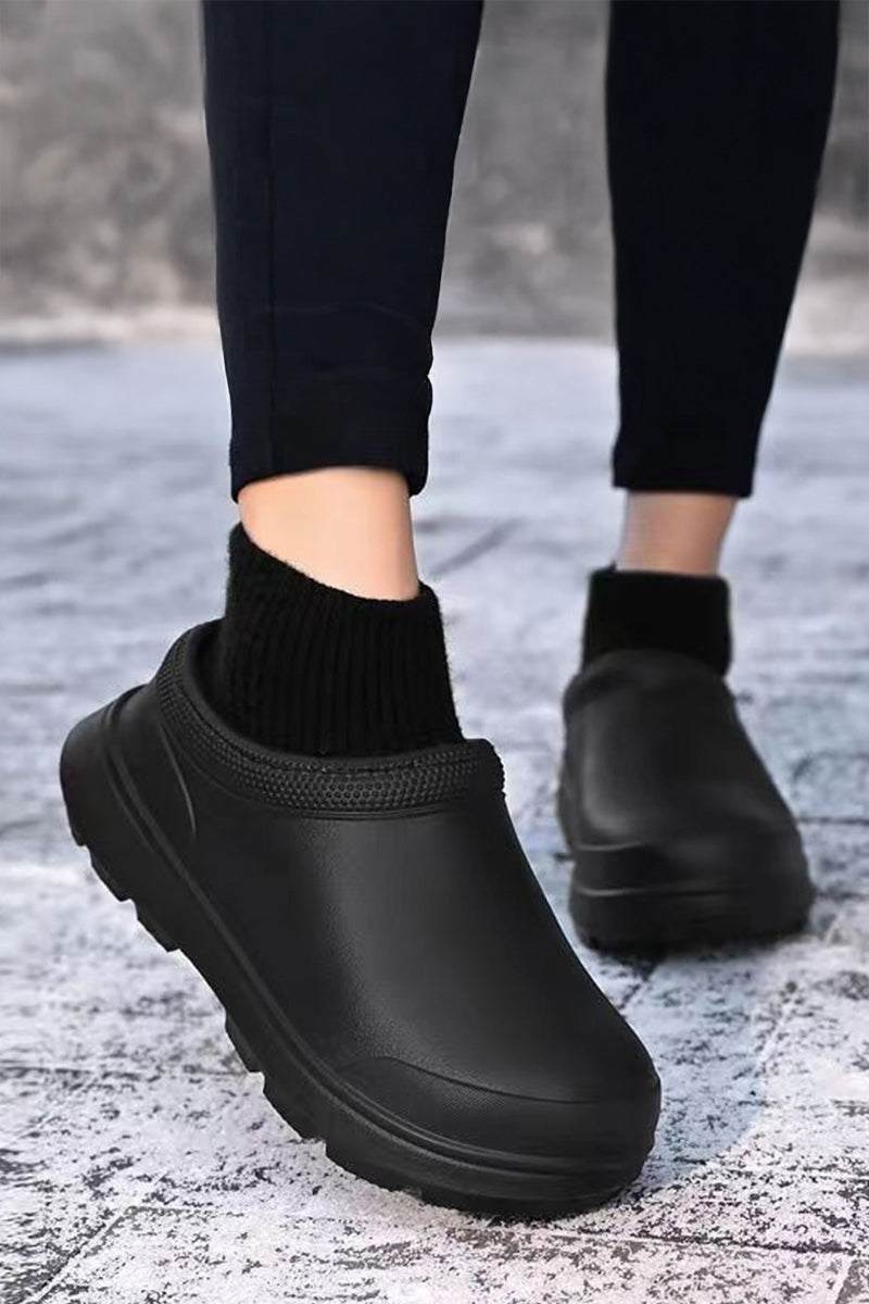 Black fleece-lined comfort clogs with waterproof exterior and textured sole for all-weather wear