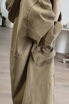 Brown travel-ready hooded windbreaker with oversized fit and snap-button pockets