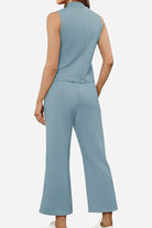Back view of a woman wearing a light blue Cotton Chic Sleeveless two-piece outfit with a sleeveless top and wide-leg pants.
