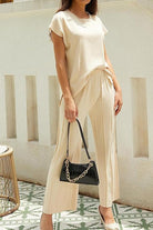 First Class Travel two-piece set in soft beige viscose-acrylic blend with pleated wide-leg pants and a relaxed top for wrinkle-resistant travel comfort