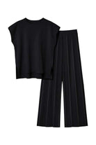 First Class Travel Two-Piece Set in black with pleated wide-leg pants and structured top