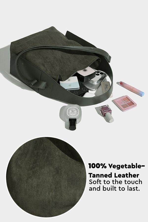 Spacious dark green Vintage Charm Bag made of soft, durable vegetable-tanned leather with dual-length straps for versatile everyday use.