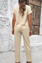 Woman wearing beige 100% cotton total comfort two-piece travel set from back view.