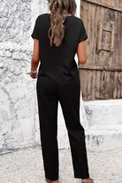 Woman wearing black 100% cotton total comfort two-piece travel set standing outdoors