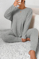 Woman wearing gray Body Confident Oversized Knit two-piece loungewear set sitting on carpet