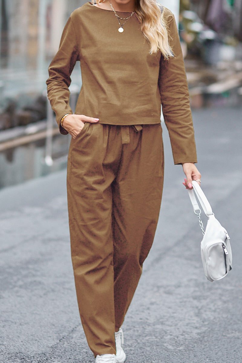 Woman wearing brown cotton relaxed two-piece Casual Chic Duo outfit walking outdoors carrying white handbag