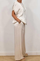 Silken Escape Satin Two-Piece Set featuring relaxed fit satin top and wide-leg pants with pockets in soft cream color