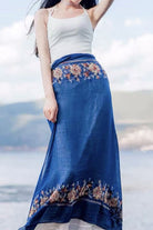 Blue embroidered travel-must shawl worn as a skirt with floral patterns and lightweight breathable fabric
